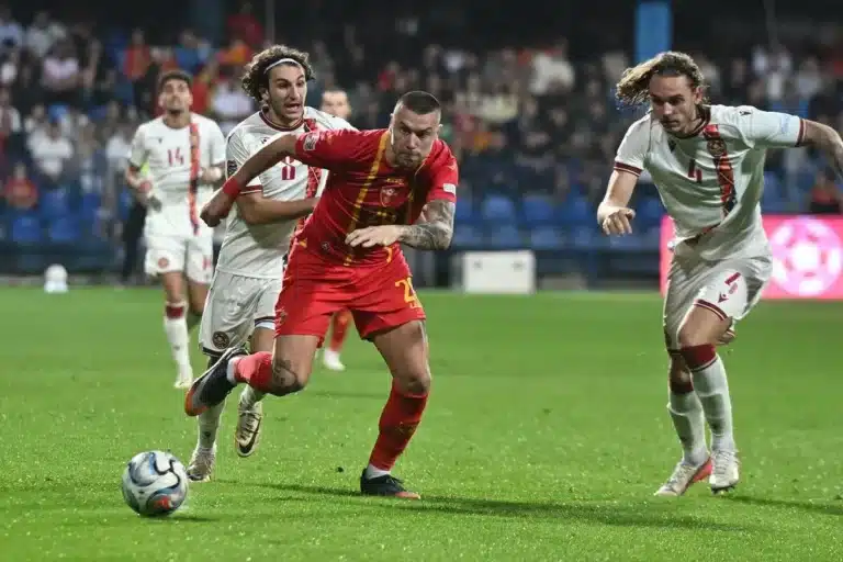 Referee reviews a VAR decision during a Nations League football match